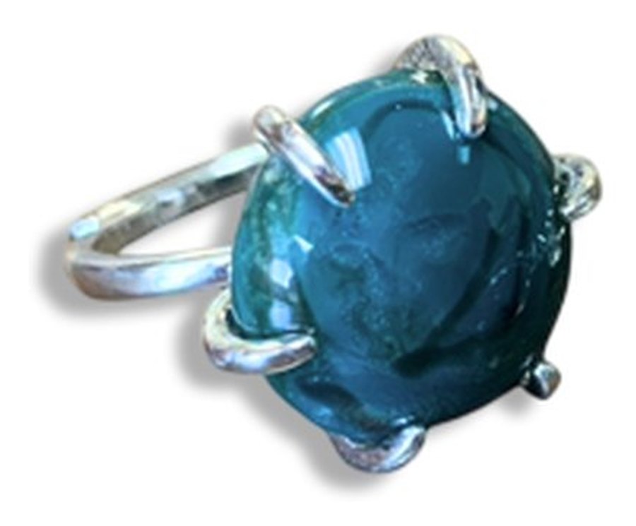 A sterling silver prong set ring with a turquoise glass stone