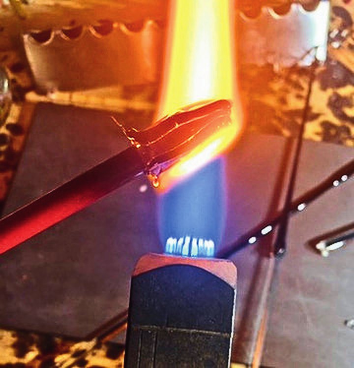 A glass rod held in the torch flame