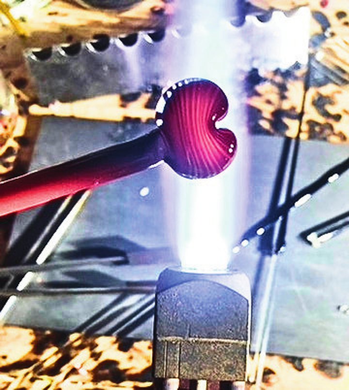 The glass shaped into a heart at the end of the rod
